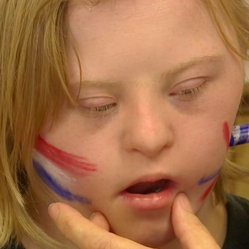 A boy getting his face painted