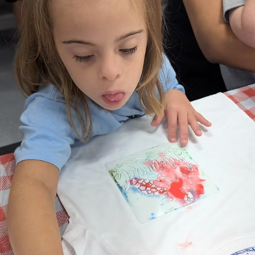 A girl drawing on a shirt