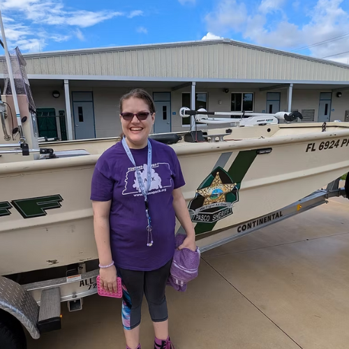 A woman in front of a boat